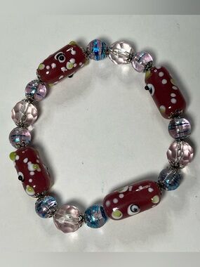 NWOT beautiful bead bracelet strung on elastic. The beads are taupe,blue & clear